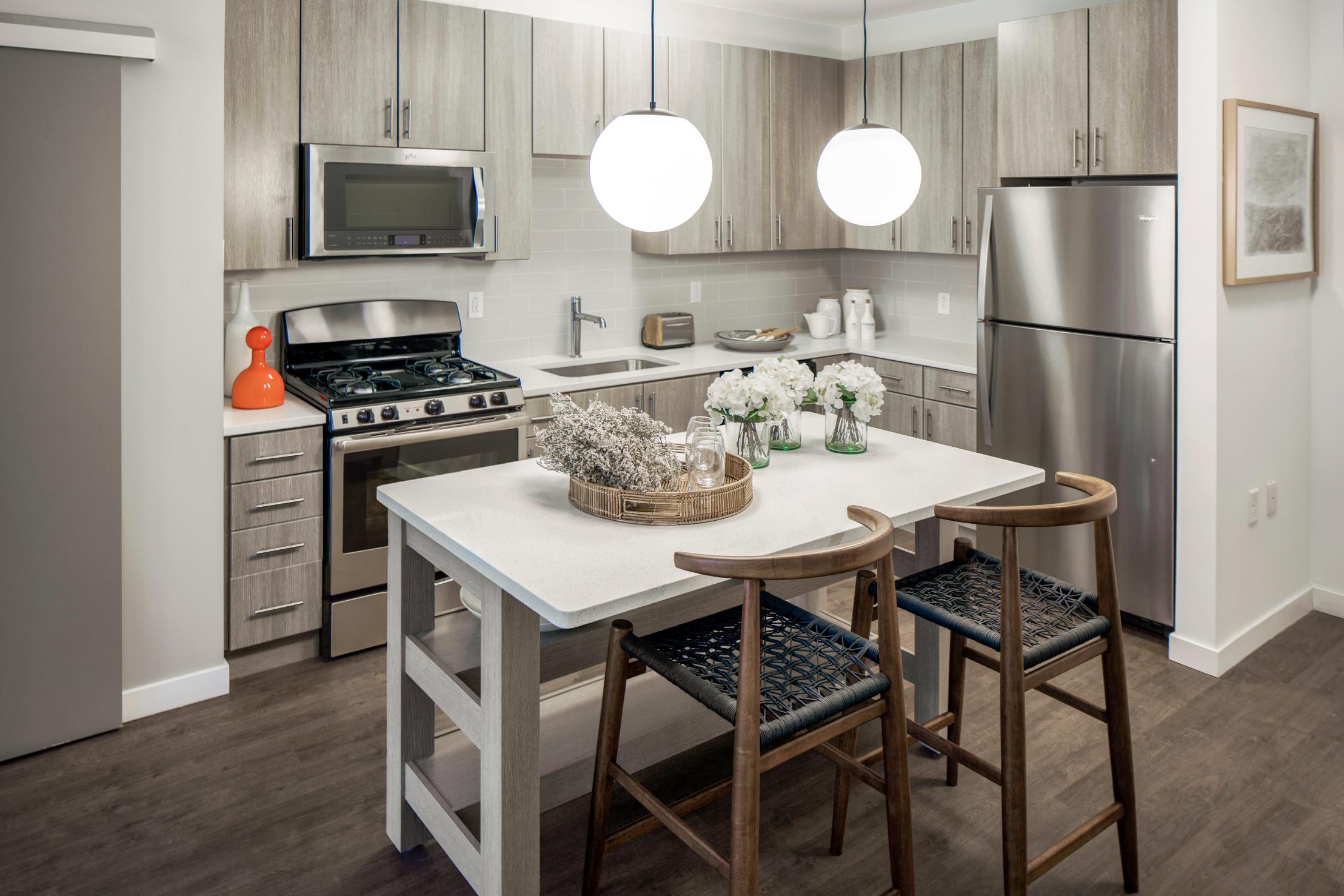 Modern kitchen with full appliances and stainless steel sink.