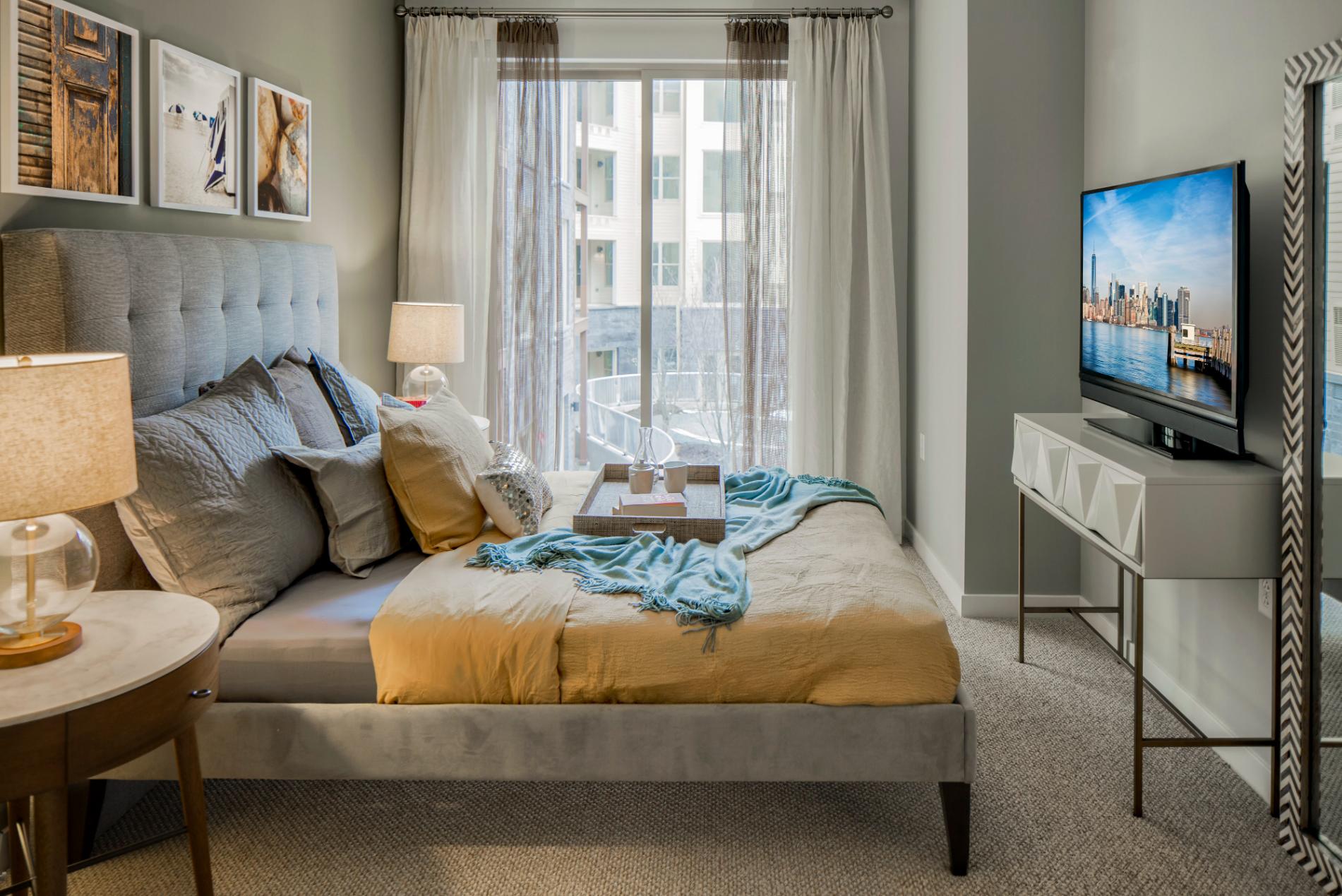 View of bed, large window and ample space for furniture