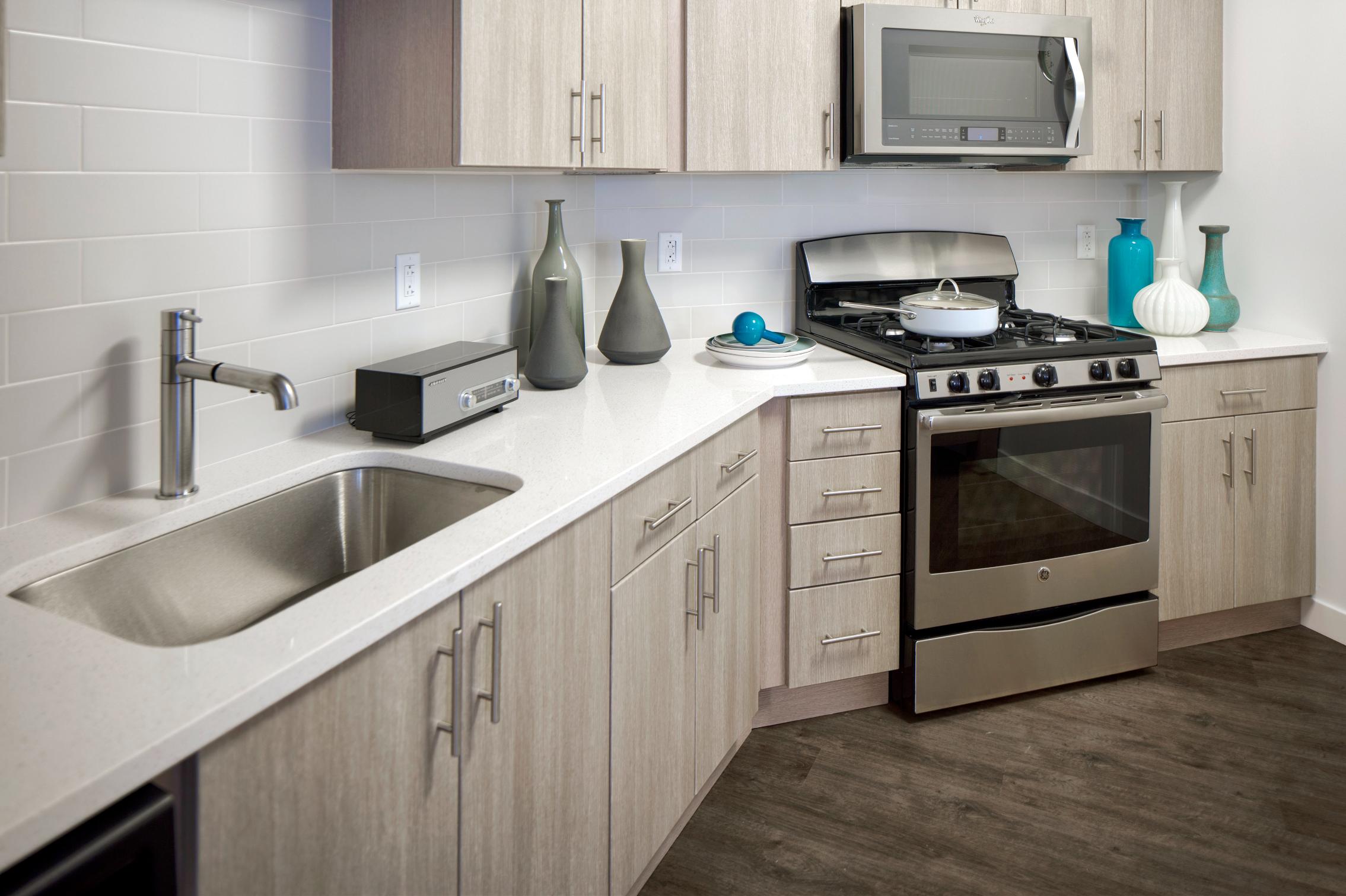 Spacious kitchen with sleek countertops, stainless appliances, and a dining area