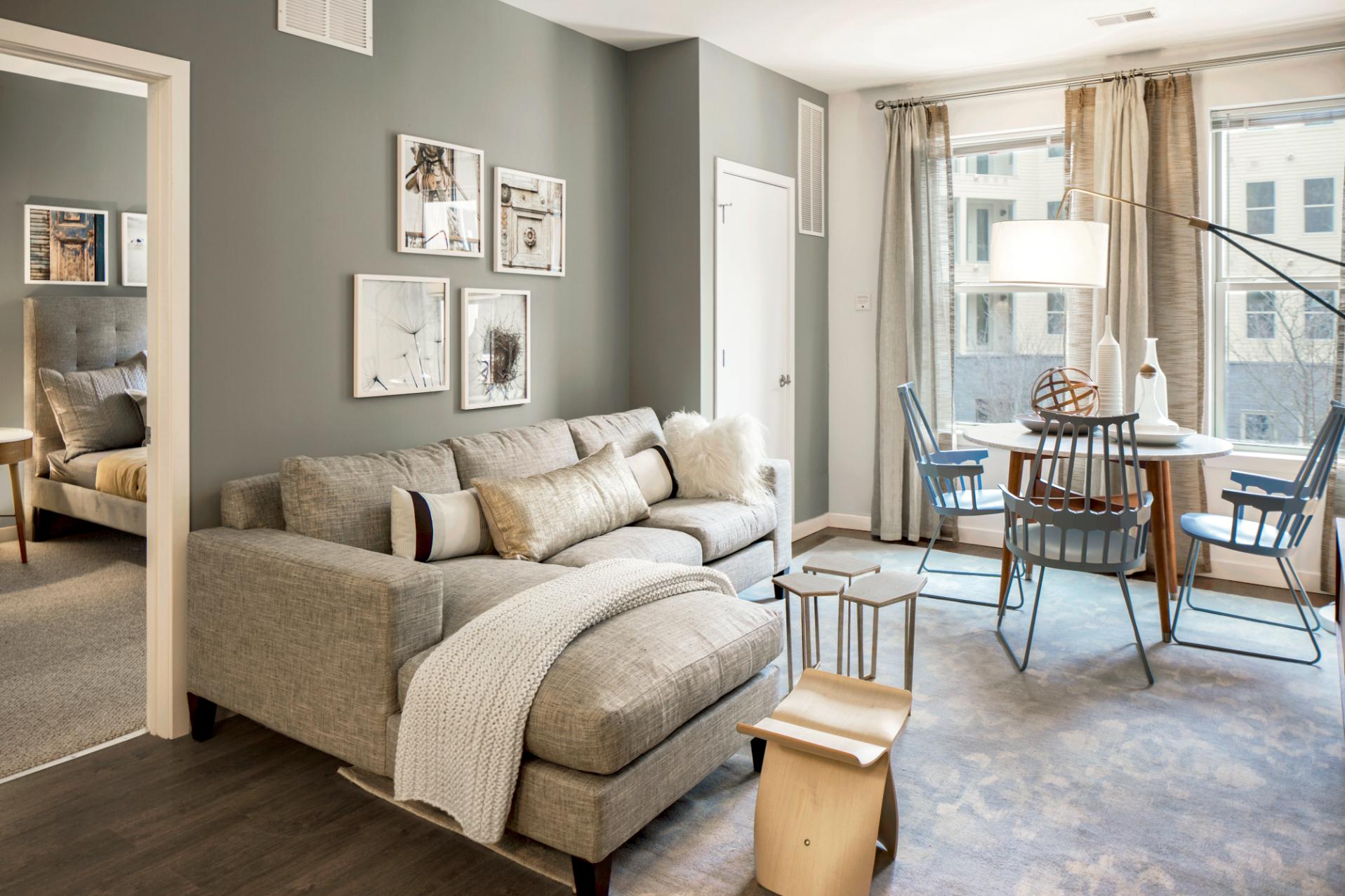 Spacious living room with a sofa, a small table, and large windows