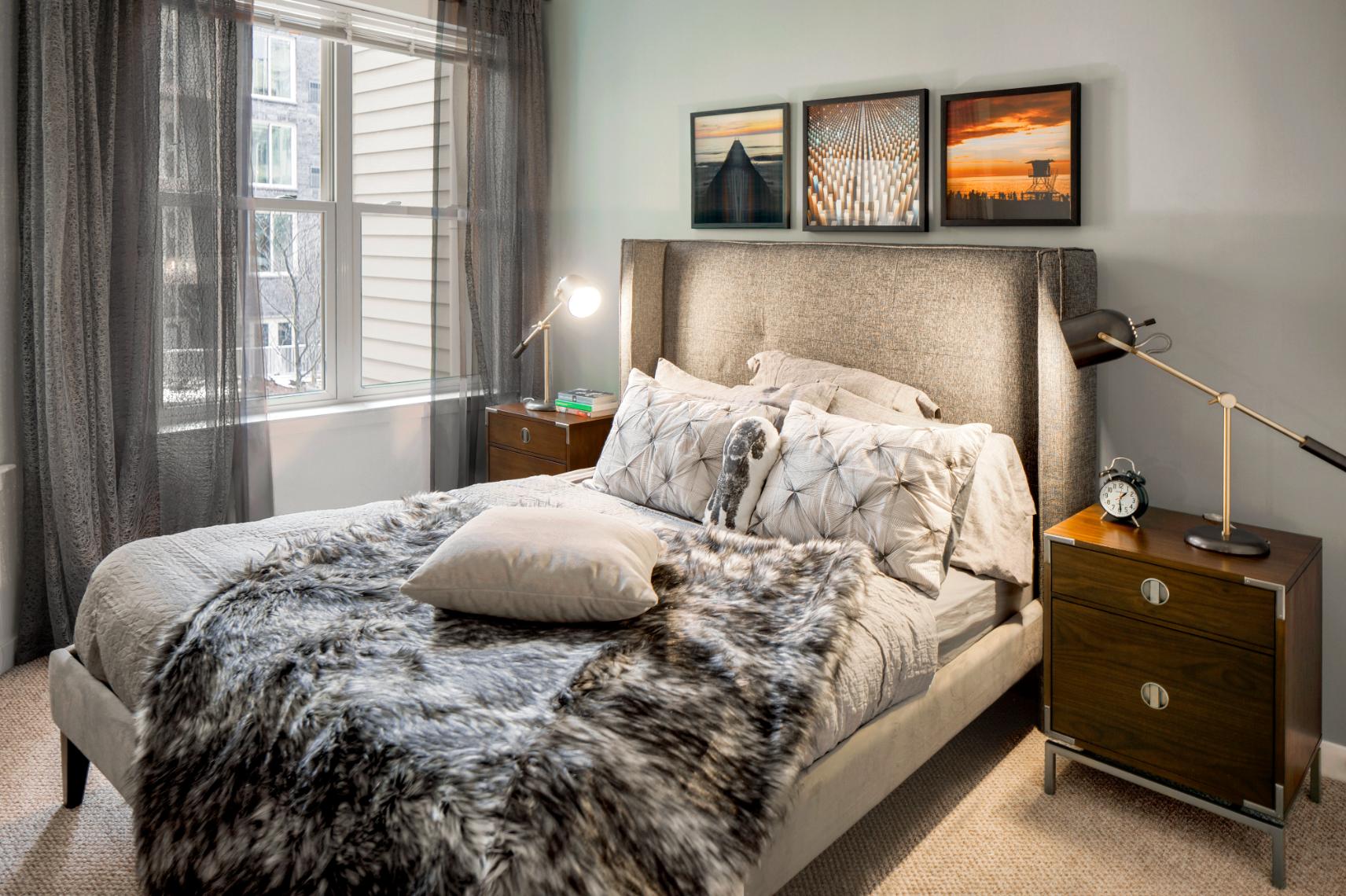 Comfortable bedroom featuring a large bed, bedside tables, and soft lighting