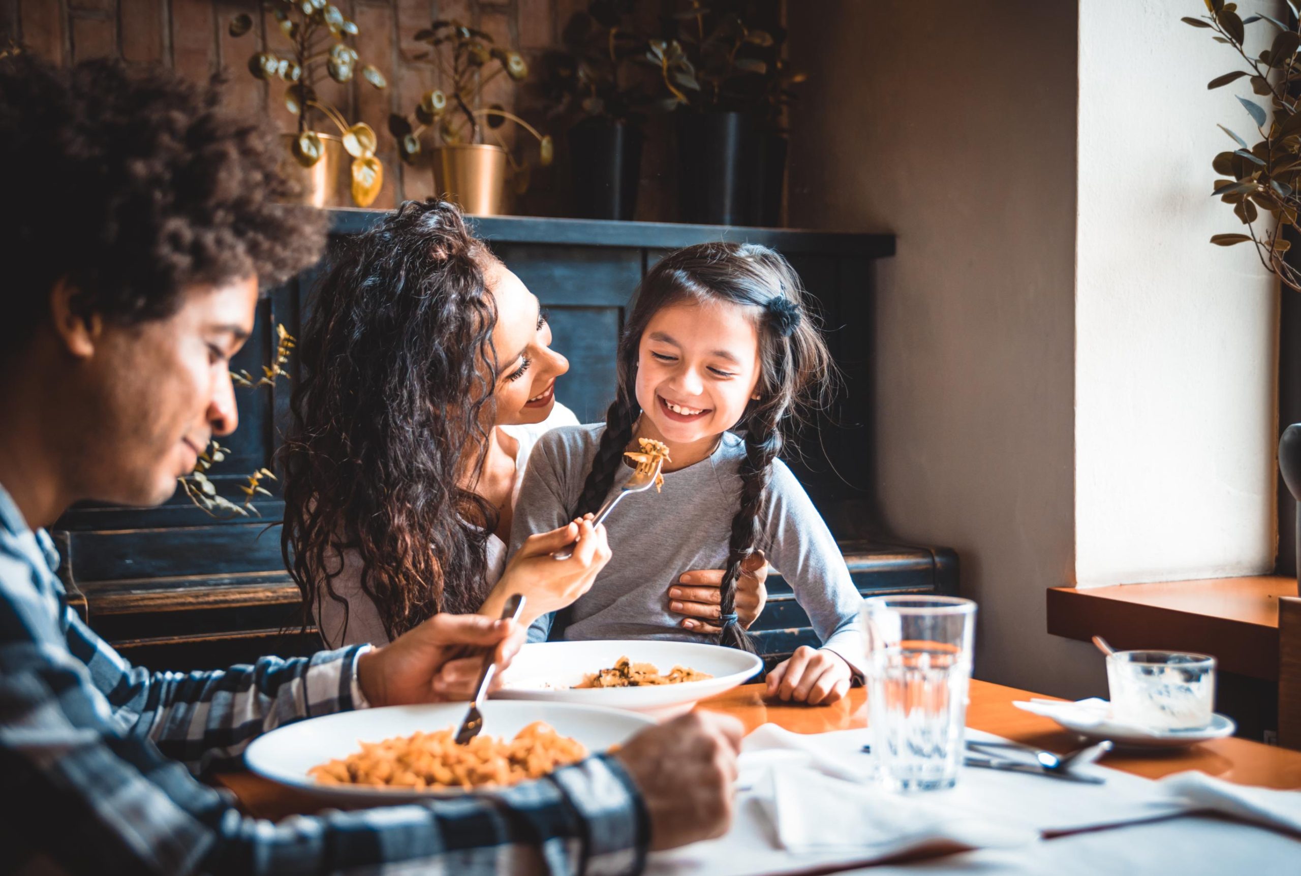 A family dining and enjoying a meal together at a restaurant.